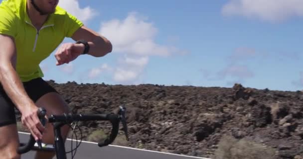 Cyclist biking looking at smartwatch while riding road bike - Cycling athlete — Stock Video