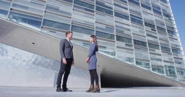 Business people - business man and business woman talking by office building — Stock Video