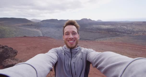 Travel tourist man taking selfie video hiking in volcano mountains of Lanzarote — Stock Video