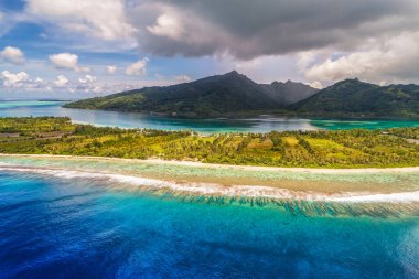 Aerial French Polynesia luxury travel honeymoon destination. Beach vacation at motu island of Huahine, Tahiti, Oceania adventure. View from above of paradise, French Polynesia, South Pacific Ocean. clipart