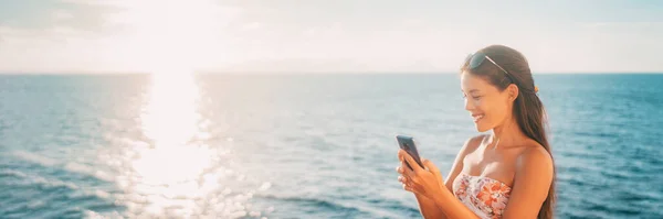 Summer vacation mobile phone tourist Asian woman using smartphone on holiday beach banner panoramic. — Photo