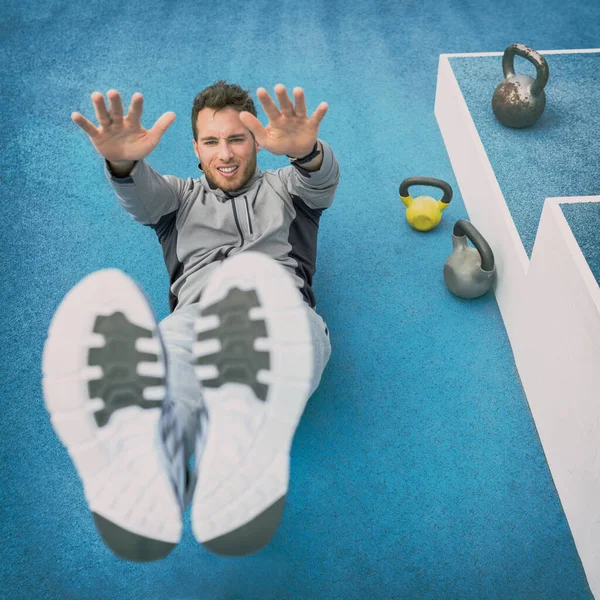 Abs exercise leg lift toe touch sit-up workout man strength training at fitness gym outdoor athletic stadium. Athlete working out crunches exercises for stomach muscles and weight loss — Stock Photo, Image