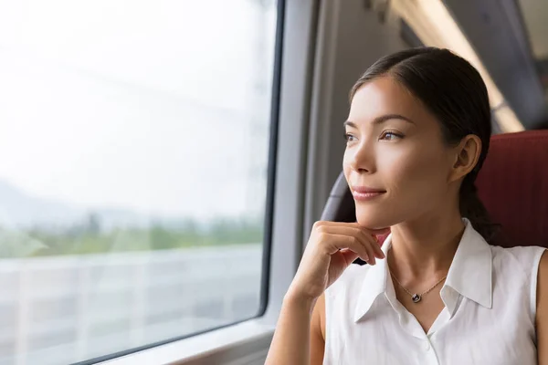 Asiatisk kvinna resenär överväger utomhus utsikt från fönstret av tåget. Ung dam på pendling resa till jobbet sitter i buss eller tåg — Stockfoto