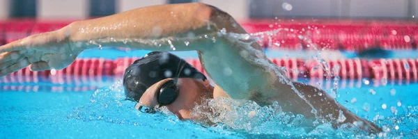 SPORTS和FITNESS概念体育运动员在游泳池训练中游泳，做自由式爬泳技术的速度竞赛。男子游泳运动员在室内体育场的小道上。横幅全景 — 图库照片