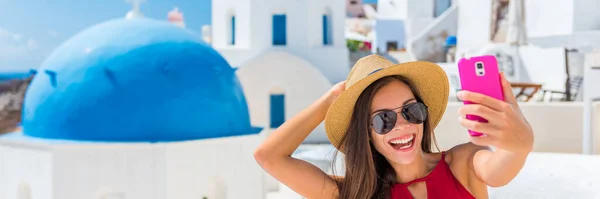 Seflie diversão viagem pessoas estilo de vida banner panorama - Mulher turística asiática sorrindo tirar foto com telefone em Oia, Santorini — Fotografia de Stock