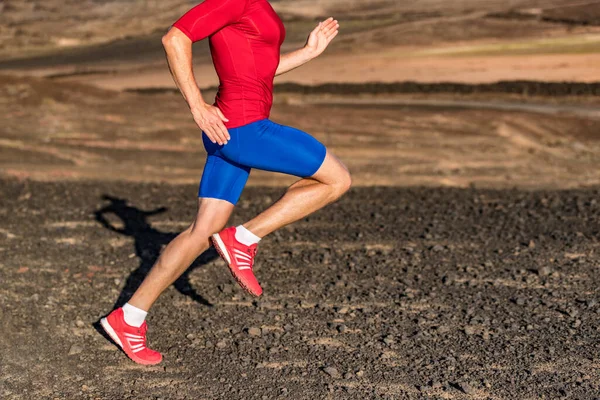 Man runner athlete running on trail run path in mountains. Legs and running shoes in motion on rocky terrain. Knee, hip, thigh, foot concept. Healthy active lower body. — 图库照片