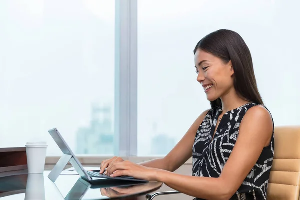 Mulher de negócios asiática digitando no laptop escrevendo on-line trabalhando na mesa de escritório. Trabalho remoto freelance em casa ou suporte ao cliente. Estilo de vida das mulheres de negócios. — Fotografia de Stock