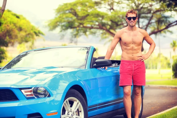 Young man new car owner driving convertible sports car on summer vacation. Beach lifestyle looking guy on spring break travel holiday. Handsome sexy topless male driver with abs feeling confident. — 图库照片