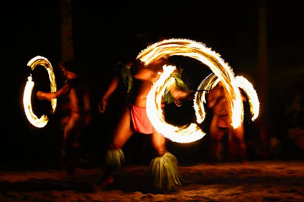 Fire dancers at Hawaii luau show, polynesian hula dance men jugging with fire torches. Stock Image