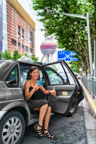 Woman using online mobile payment app for taxi cab