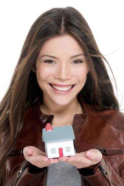 Mortgage, home insurance new house owner care concept Happy young first time homeowner buying new house. Real estate agent woman showing small toy model on hands —  Fotos de Stock