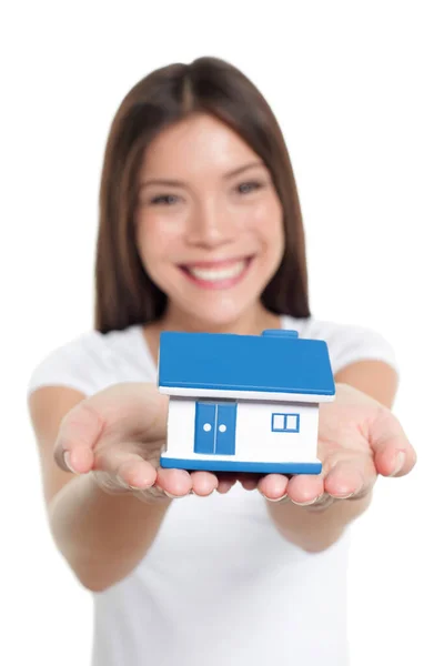 Real estate house market buying home insurance concept. Happy Chinese woman holding small toy home for protection, banking, mortgage, savings, ownership — Stock Photo, Image