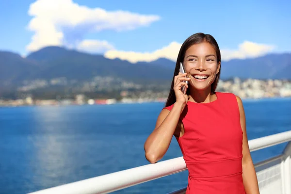 Happy asian woman talking on the phone in vancouver city harbour on summer day. Beautiful landscape of canadian nature river and mountains. Businesswoman on smartphone lifestyle — Stok fotoğraf