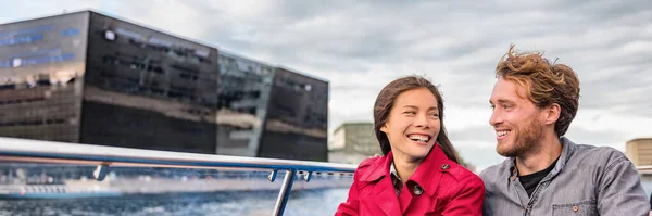 Copenhagen tourists couple on city boat cruise tour of the black diamond Royal library, famous architecture building, Denmark, Europe travel. Panoramic banner of people traveling lifestyle. — Stock Photo, Image