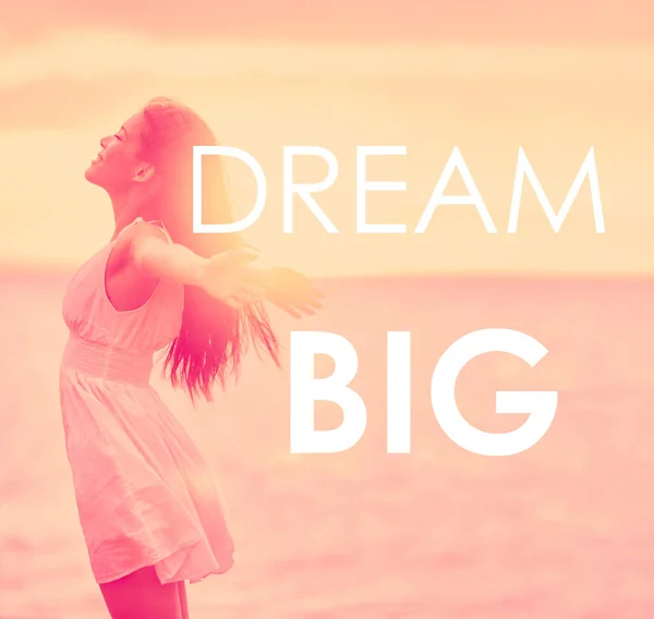 DREAM BIG inspirational message written on motivational picture of carefree girl happy with arms open in freedom at beach sunset. Life happiness motivation quote for dreaming big in your life — 스톡 사진