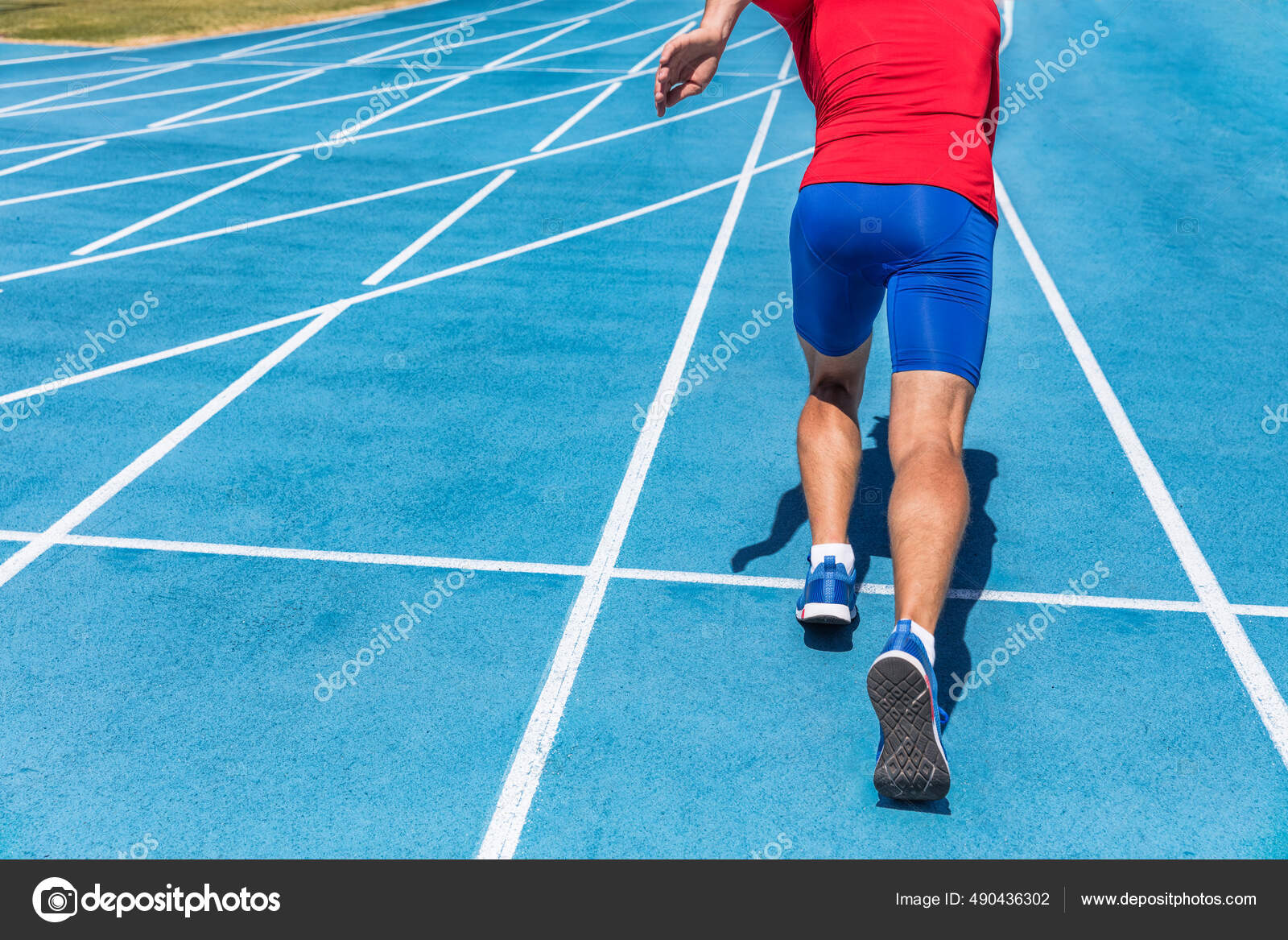 Runner athlete starting running at start of run track on blue