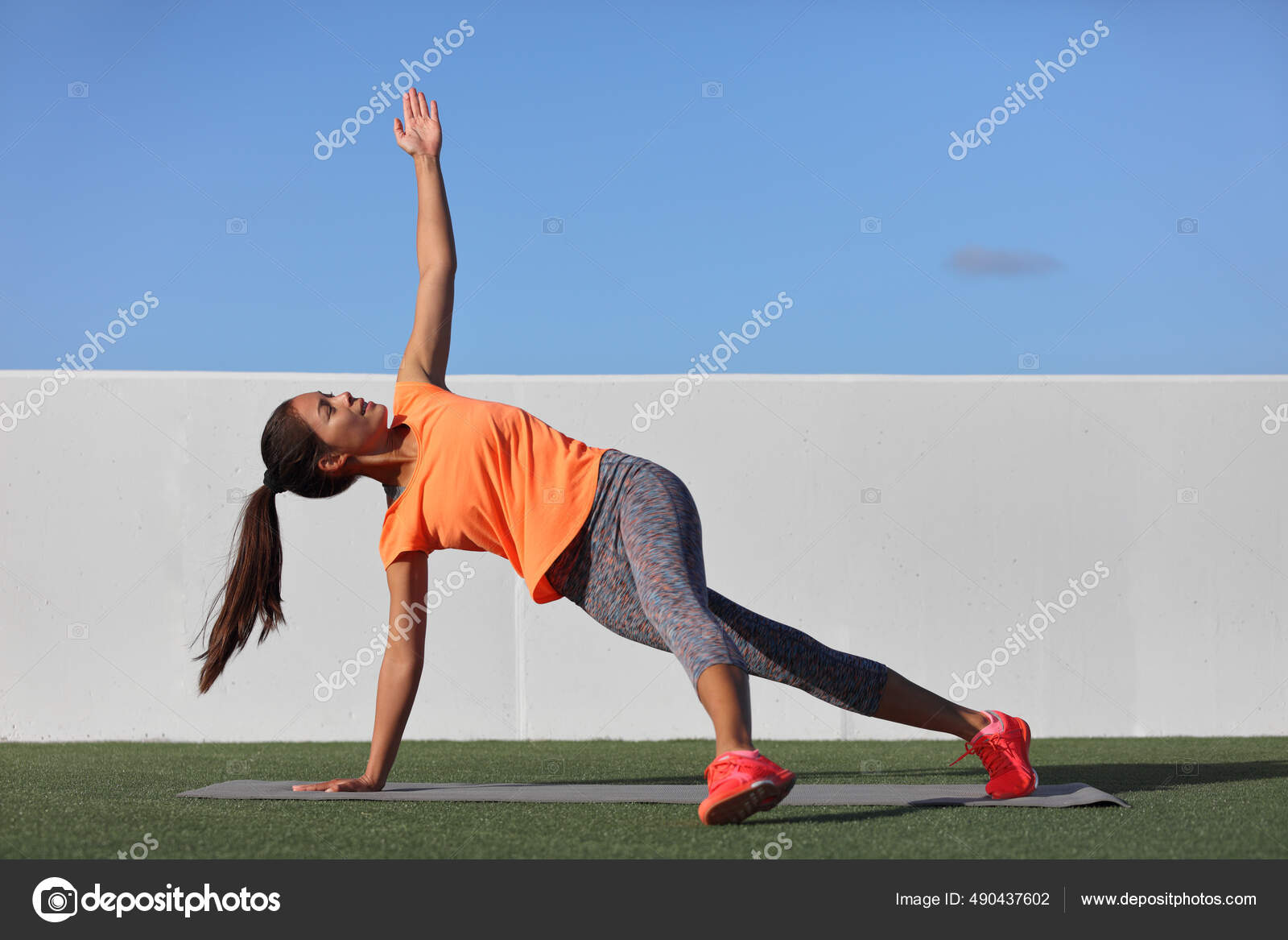 Yoga pose variation fitness girl doing the fallen triangle assited with  leg. Asian woman doing side plank with lateral leg raise. Planking exercise  for body core, bodyweight workout at home gym. Stock