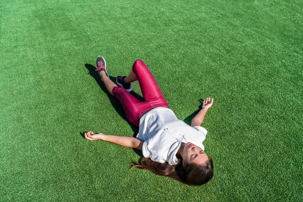 Tired athlete lying down after intense workout — Stock Photo, Image