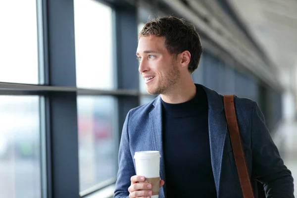 Buon uomo d'affari che va a lavorare bevendo caffè - stile di vita di viaggio o pendolari mattutini vita urbana. Giovane professionista vicino alla finestra in edificio per uffici o in aeroporto terminale volo in business class. — Foto Stock