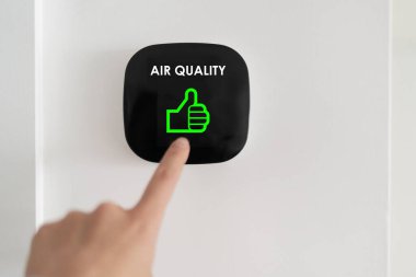 Good air quality indoor smart home domotic touchscreen system. air. Woman touching touchscreen checking air purifier filter at green level with thumbs up graphics. clipart