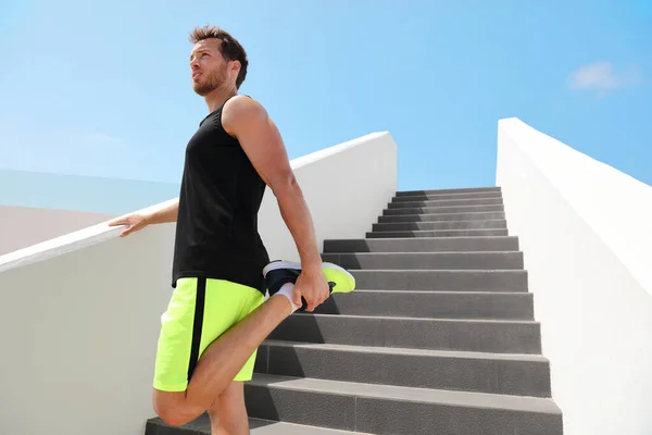 Muscoli delle gambe stretch fit uomo corridore preparandosi a correre stretching gambe riscaldamento quad allunga esercizi su scale esterne per cardio HIIT allenamento estivo. — Foto Stock