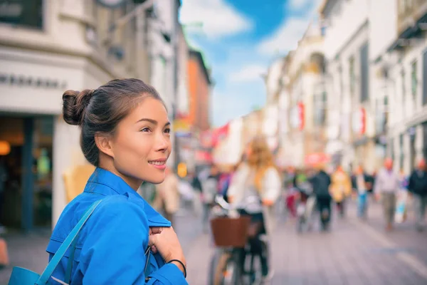 Tourist chinese young woman walking in city street shopping on travel vacation in fall autumn spring happy. Copenhagen city, Denmark — Stock Photo, Image