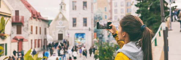 Quebec city old town tourist taking picture with mobile phone of famous wall art mural in Place Royale panoramic banner. Asian chinese woman on Autumn Canada travel — Stock Photo, Image