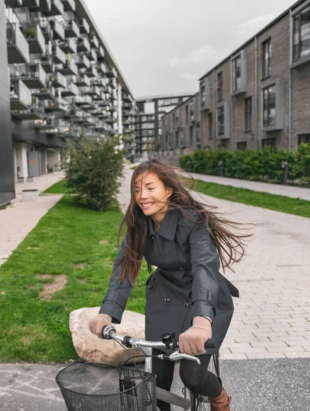 City bike Asian girl happy riding bicycle commuting outside condo apartment building street — Stock Photo, Image