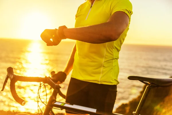 Athlete cyclist man using fitness smartwatch — Stock Photo, Image