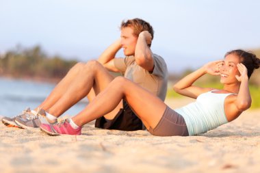 Couple working out on beach clipart