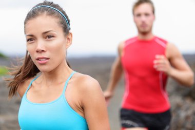 Girl jogging with man in background clipart