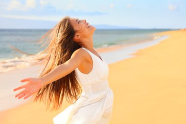 Woman on beach enjoying nature clipart