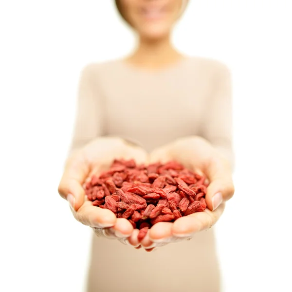 Woman showing dried goji berries — Stock Photo, Image