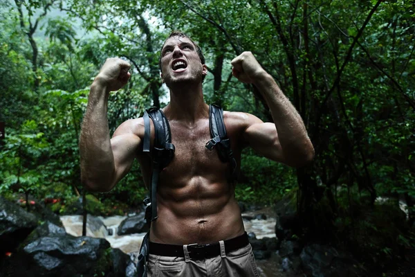 Man cheering in jungle rainforest — Stock Photo, Image