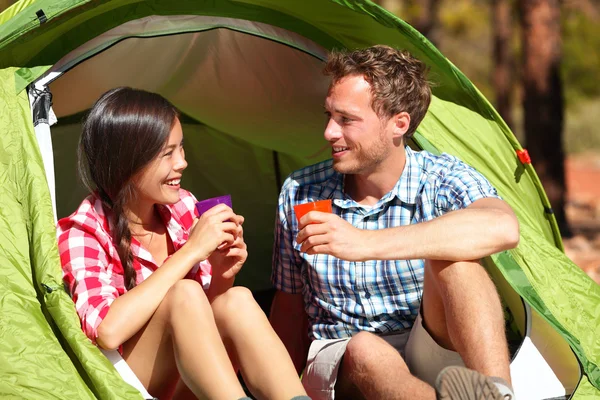 Couple drinking water in tent — Stock Photo, Image