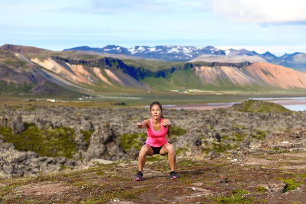 Girl exercising outdoors doing jump squat — Stock Photo, Image