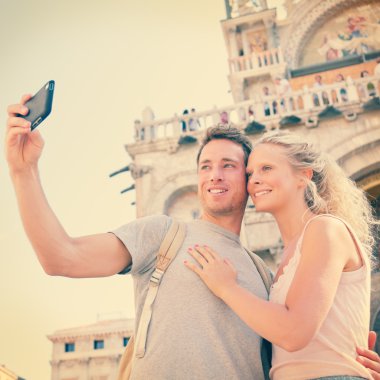 Couple taking photo with smartphone clipart
