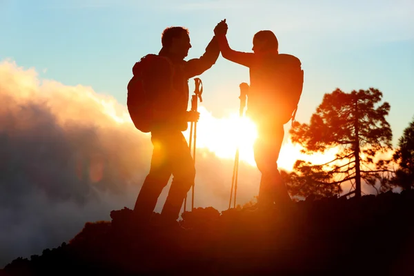 Hiking people reaching summit top high five — Stock Photo, Image