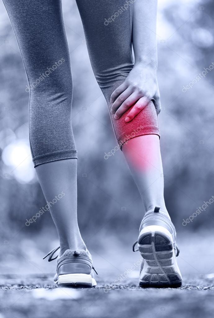 Woman running clutching calf muscle — Stock Photo © Maridav 62143907