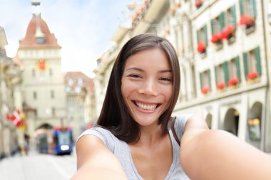 Woman taking selfie in Bern clipart