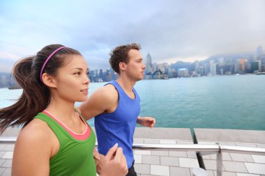 Couple jogging in Hong Kong city clipart