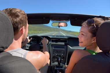 Couple driving car on road trip clipart