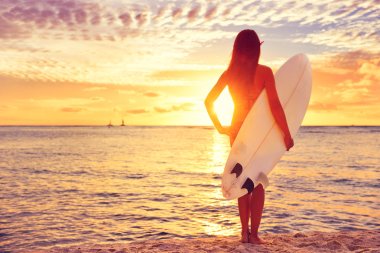 Surfer girl surfing looking at ocean clipart