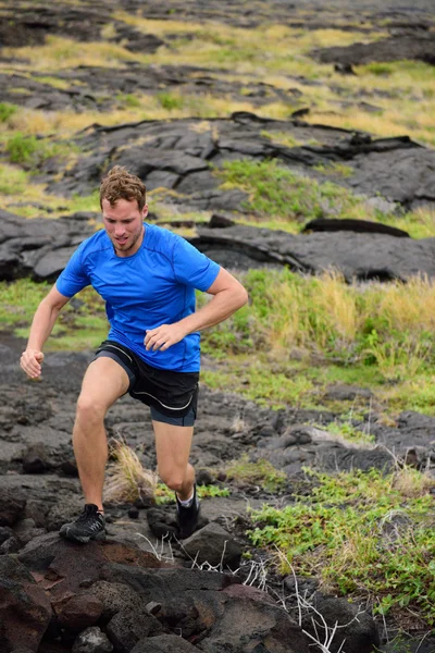 Man trail running on volcanic rocks — Stock Photo, Image