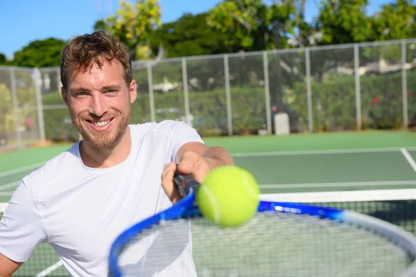 Man showing ball and racket — Stock Photo, Image