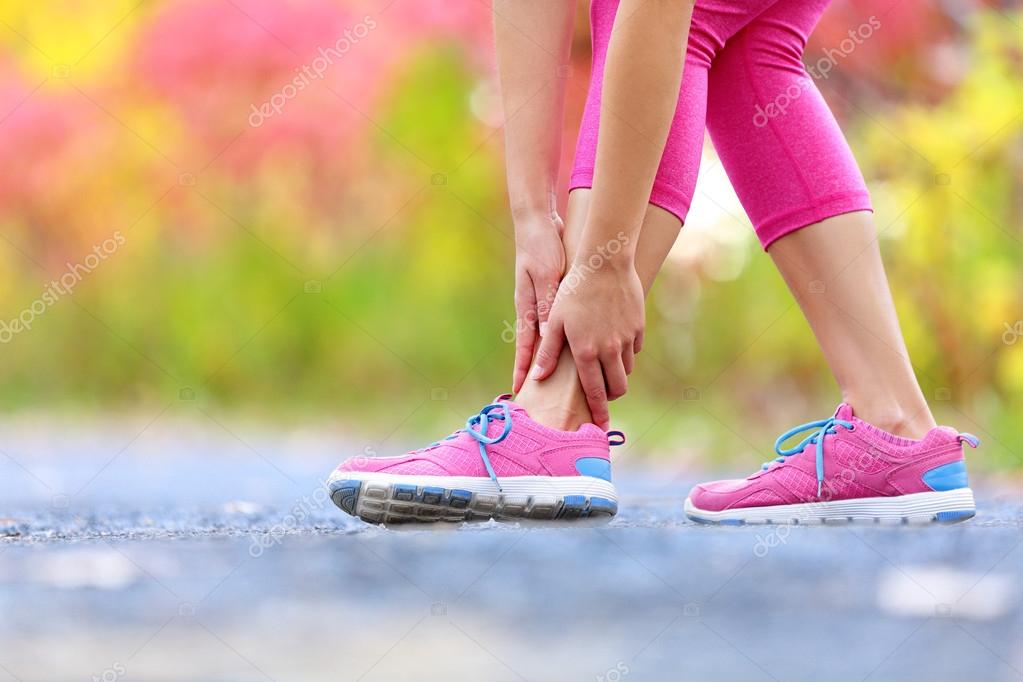 Female runner touching foot in pain — Stock Photo © Maridav 72655697