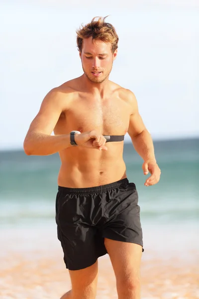 Man athlete checking pulse during workout — Stock Photo, Image