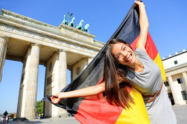 Woman happy at Berlin waving flag — Stock Photo, Image