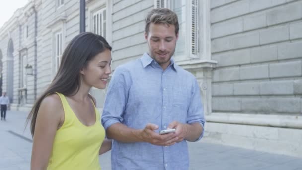 Ζευγάρι χρησιμοποιώντας έξυπνο τηλέφωνο στην πόλη — Αρχείο Βίντεο