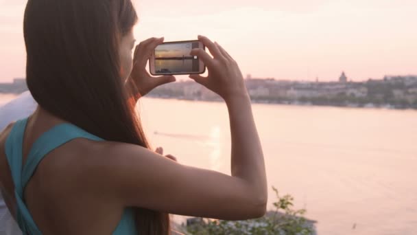 Turista tomando fotografías del atardecer en Estocolmo — Vídeos de Stock